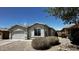 Single-story home featuring desert landscaping, a tile roof, and a two-car garage at 43890 W Bedford Dr, Maricopa, AZ 85138