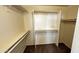 Empty walk-in closet with shelves and racks for ample storage at 43890 W Bedford Dr, Maricopa, AZ 85138