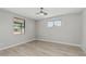 Bedroom with wood-look floors, neutral walls, ceiling fan, and window providing natural light at 4441 N 27Th Dr, Phoenix, AZ 85017
