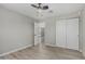 Bedroom features include ceiling fan, wood-look flooring and closet with slider doors at 4441 N 27Th Dr, Phoenix, AZ 85017