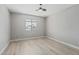 Bedroom with wood-look floors, neutral walls, ceiling fan, and window providing natural light at 4441 N 27Th Dr, Phoenix, AZ 85017