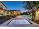 Backyard view featuring a luxurious spa and inviting pool, with ambient outdoor lighting for relaxing evenings at 4610 E Meadowview Dr, Gilbert, AZ 85298