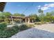 Expansive backyard featuring a pool, covered patio, and desert landscaping at 4610 E Meadowview Dr, Gilbert, AZ 85298