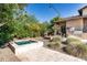 Beautiful backyard with a pool, fire pit, built-in grill, and lush landscaping at 4610 E Meadowview Dr, Gilbert, AZ 85298