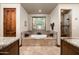 A luxurious bathroom featuring a deep soaking tub under a window and a separate walk-in shower at 4610 E Meadowview Dr, Gilbert, AZ 85298