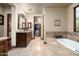 Elegant bathroom featuring double granite vanities, tub, and walk-in closet at 4610 E Meadowview Dr, Gilbert, AZ 85298