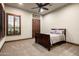 A bedroom with a neutral decor, carpeted floors, shutters, and a queen size bed at 4610 E Meadowview Dr, Gilbert, AZ 85298