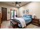 Bedroom with neutral colors, a bed, desk area, and access to the backyard through glass doors at 4610 E Meadowview Dr, Gilbert, AZ 85298