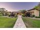 Stunning single-story home with beautiful landscaping and a paver walkway leading to the front door at 4610 E Meadowview Dr, Gilbert, AZ 85298
