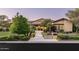 Charming single-story home with mature trees, manicured landscaping and a brick walkway to the front door at 4610 E Meadowview Dr, Gilbert, AZ 85298