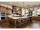 Gourmet kitchen features island with seating and custom range hood at 4610 E Meadowview Dr, Gilbert, AZ 85298