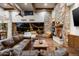 Spacious living room with wood floors, stone fireplace and access to the backyard at 4610 E Meadowview Dr, Gilbert, AZ 85298