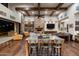 Open-concept living room with wood floors, a stone fireplace, and a dining table at 4610 E Meadowview Dr, Gilbert, AZ 85298