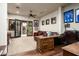 An office space with wood floors, a desk, a seating area, and doors to the backyard at 4610 E Meadowview Dr, Gilbert, AZ 85298