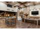 Bright living room features wooden floors, stone fireplace, exposed beam ceilings and an open floorplan at 4610 E Meadowview Dr, Gilbert, AZ 85298