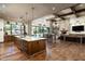 An open floor plan with kitchen, bar seating, fireplace, and backyard views at 4610 E Meadowview Dr, Gilbert, AZ 85298