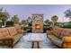Inviting outdoor space with comfortable seating and a stone fireplace perfect for relaxing at 4610 E Meadowview Dr, Gilbert, AZ 85298