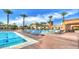 Resort-style pool area with lounge chairs, palm trees, and shaded cabanas at 4610 E Meadowview Dr, Gilbert, AZ 85298