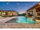 A stunning pool with waterfall features and an outdoor gazebo, enhanced by string lights for evening charm at 4610 E Meadowview Dr, Gilbert, AZ 85298