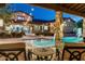 Relaxing poolside view with stone pillars, string lights, and comfortable seating at 4610 E Meadowview Dr, Gilbert, AZ 85298