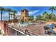 Community pool features water slide, tower, lounge chairs, tables, and beautiful rock feature at 4610 E Meadowview Dr, Gilbert, AZ 85298