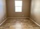Cozy bedroom features large windows, neutral paint, and tiled floors at 5345 W Marcus Dr, Phoenix, AZ 85083