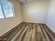 Bedroom showcasing wood-look floors and a window for natural light at 5345 W Marcus Dr, Phoenix, AZ 85083
