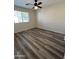 Bedroom with wood-look floors and a window for natural light at 5345 W Marcus Dr, Phoenix, AZ 85083