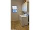 Functional laundry room featuring a window, washer, dryer, and storage cabinets at 5345 W Marcus Dr, Phoenix, AZ 85083