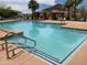 Community pool featuring well-kept landscaping, lounge chairs, and shaded cabanas at 5345 W Marcus Dr, Phoenix, AZ 85083
