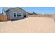 Expansive backyard with new construction home featuring stucco exterior, and wood fence at 5614 W Saint Moritz Ln, Glendale, AZ 85306
