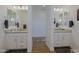 Bathroom with dual vanities, mirrors, and wood-look tile flooring at 5614 W Saint Moritz Ln, Glendale, AZ 85306