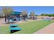 Community amenity area featuring outdoor kitchen, fire pit, cornhole, and seating at 5614 W Saint Moritz Ln, Glendale, AZ 85306