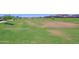 Large green space in community area with grass, trees, and drainage at 5614 W Saint Moritz Ln, Glendale, AZ 85306