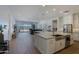 Open-concept kitchen and living area with a large island, stainless steel appliances, and sliding glass doors to the backyard at 5614 W Saint Moritz Ln, Glendale, AZ 85306