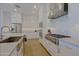 Kitchen featuring white cabinets, stainless steel appliances, a stylish tile backsplash, and a spacious island with sink at 5614 W Saint Moritz Ln, Glendale, AZ 85306