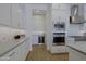 Bright kitchen with white cabinetry, stainless steel appliances including a built-in oven, and a view of the pantry at 5614 W Saint Moritz Ln, Glendale, AZ 85306