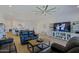 Open-concept living room showcasing wood-look tile, comfortable seating, and an entertainment center at 5614 W Saint Moritz Ln, Glendale, AZ 85306