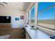 Bright office space featuring large windows, built-in desk, and wood-look tile floors at 5614 W Saint Moritz Ln, Glendale, AZ 85306