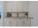 This flex room has upper and lower cabinets with a counter top and is perfect as a craft room or additional storage at 5614 W Saint Moritz Ln, Glendale, AZ 85306