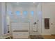 Expansive walk-in shower with white tile surround, a bench, and neutral accents at 5614 W Saint Moritz Ln, Glendale, AZ 85306