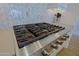 Close up of the stainless steel stove top with several burners and knobs, as well as a matching decorative backsplash at 5614 W Saint Moritz Ln, Glendale, AZ 85306