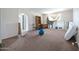 Untidy bedroom features carpet flooring, neutral walls, and archway entrances to other rooms at 6128 W Columbine Dr, Glendale, AZ 85304