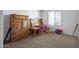 Spacious bedroom with carpet, window, and wooden furniture for  at 6128 W Columbine Dr, Glendale, AZ 85304