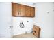 Laundry room with upper cabinets and hookups for washer and dryer at 6128 W Columbine Dr, Glendale, AZ 85304