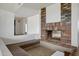 Cozy living room with a brick fireplace, unique step-up area, and an open floor plan at 6128 W Columbine Dr, Glendale, AZ 85304