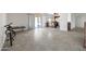 Open-concept living space featuring tile flooring and kitchen access, perfect for entertaining at 6128 W Columbine Dr, Glendale, AZ 85304