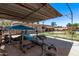 View of backyard with playset and concrete area with exercise equipment at 6814 W Berkeley Rd, Phoenix, AZ 85035