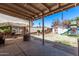 Spacious backyard featuring a covered patio, rock fire pit, storage shed and a playset at 6814 W Berkeley Rd, Phoenix, AZ 85035