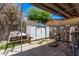 Backyard area featuring workout equipment, storage sheds and an overgrown yard at 6814 W Berkeley Rd, Phoenix, AZ 85035
